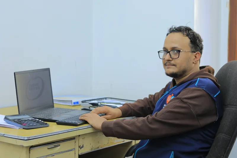 A Nahbal team member at his office computer