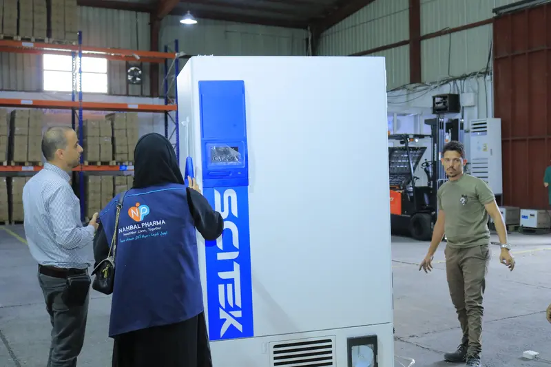 A large device being positioned within the warehouse receiving area