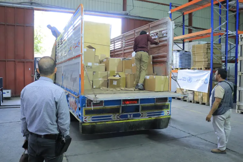 Cartons being unloaded from a delivery vehicle inside a warehouse